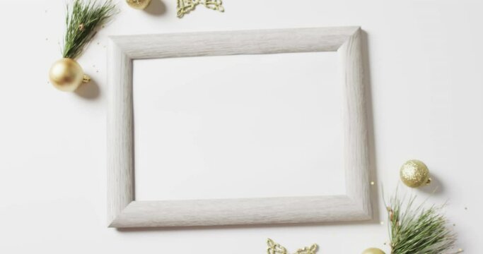 Video of christmas decorations and white frame with copy space on white background