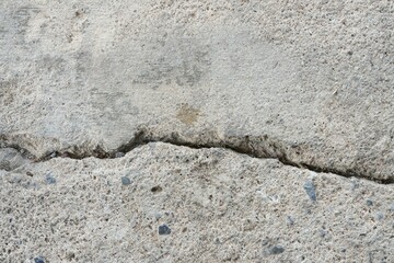 Cracked concrete floor separated into two parts