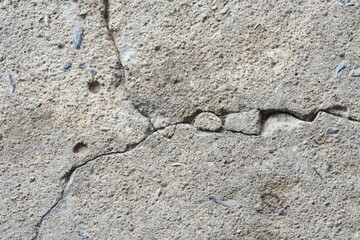 Cracked concrete floor separated into three parts