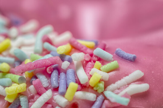 Close-up of hundreds and thousands on top of a pink donut
