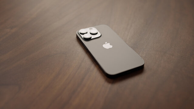 Saint-Petersburg, Russia - Circa December, 2022: iPhone 14 Pro Space Black on walnut wood table