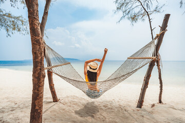 Traveler asian woman relax and travel in hammock on summer beach at Koh Rap Samui in Surat Thani Thailand - 662143901