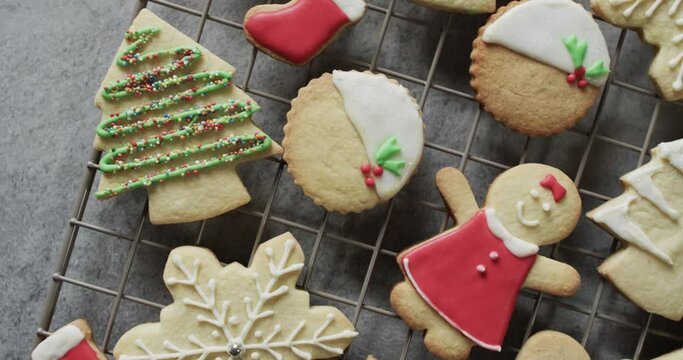 Video of christma cookies decorated sugar icing with copy space on grey background