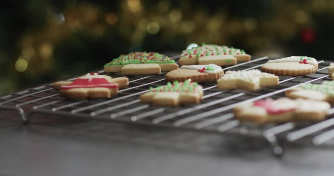Video of christma cookies decorated sugar icing with copy space on grey background