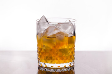 whiskey in a glass filled with ice cubes