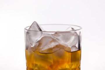 whiskey in a glass filled with ice cubes