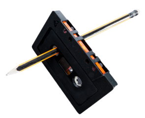 Rewinding a cassette tape manually with a pencil. Creativity concept. 80's and 90's.4