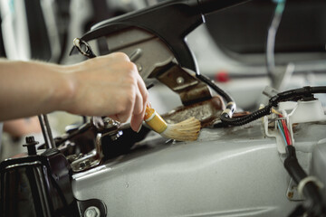 Worker make dry cleaning the car interior using a special brush with foam