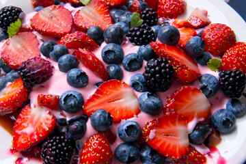 A plate of food with strawberries and blueberries on it