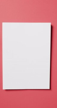 Vertical video of white card with copy space on red background