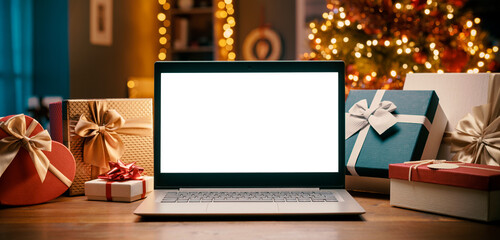 Laptop with blank screen and Christmas gifts
