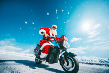 Full length of Santa Claus who ride vintage motorbike deliver gifts Christmas eve on the road