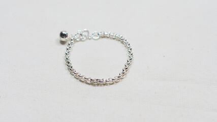 Silver bracelet display on white cloth background