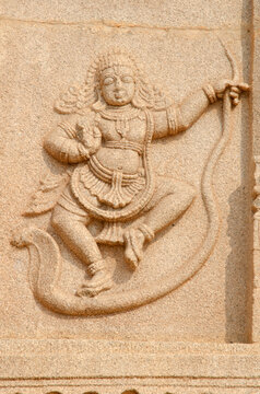 Kaliya mardana Krishna sculpture  on exterior wall of Ramachandra temple, Hampi, Karnataka, India