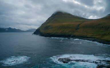 Impression of the wild Faroe coast in the North Atlantic. Paralyzing cliffs