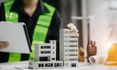 male architect hands making model house. Man architect working in the office.