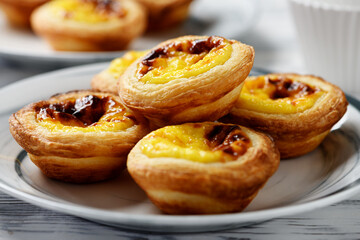 Pastel de nata or Portuguese egg tart. Small tart with a crispy puff pastry crust and a custardy...