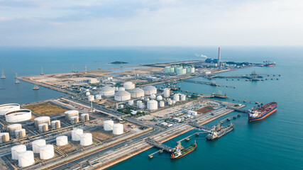 Fototapeta premium Aerial view or oil terminal is industrial facility for storage tank of oil and LPG Petrochemical. oil manufacturing products ready for transport and business transportation, LPG Tank, CNG tank