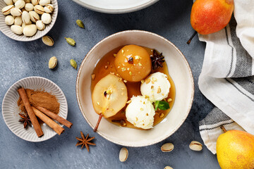 Poached pears with spices in syrup and  ice cream balls . Delicious dessert. top view