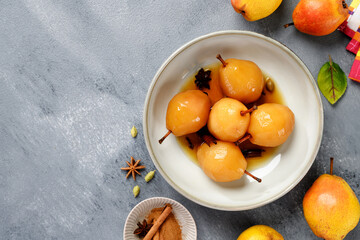 Poached pears with spices in syrup . Delicious dessert, top view