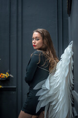 Amazing beautiful girl in black with angels wings Halloween cosplay