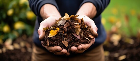 Gardener enriches soil with compost mulch With copyspace for text