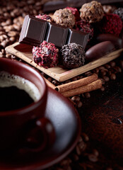 Various chocolates  and cup of black coffee.