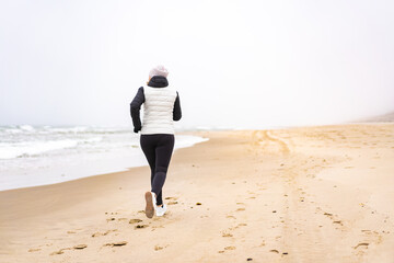 Beautiful woman running on beach