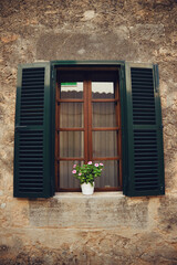 Fototapeta na wymiar rustic window with Majorcan blinds