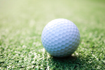 Golf ball placed on artificial grass.