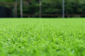 Artificial grass close-up. Artificial turf background. Artificial turf of Soccer football field. Short cut real grass on the edge of the pitch in the stadium. - obrazy, fototapety, plakaty