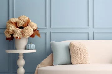 Fototapeten A bouquet of dry hydrangea in a vase in the interior of a blue living room. Autumn atmosphere. © July P
