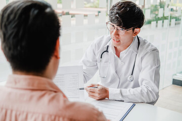 Doctors and patients consulting and diagnostic examining sit and talk. At the table near the window in the hospital medicine concept