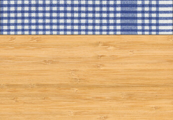 Blue white plaid napkin on bamboo wooden floor table or cutting board