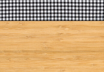 Black white plaid napkin on bamboo wooden floor table or cutting board