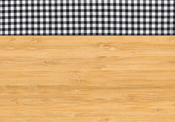 Black white plaid napkin on bamboo wooden floor table or cutting board