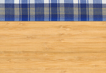 Blue white plaid napkin on bamboo wooden floor table or cutting board