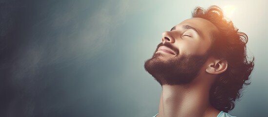 Man meditating with gratitude opening eyes to hopeful sky smiling in contemplation With copyspace for text