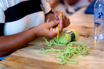 Crochet Club. Black skinned woman knitting