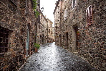 Fototapeta na wymiar a narrow street with traditional houses in Radicofani, province of Siena, Tuscany, Italy