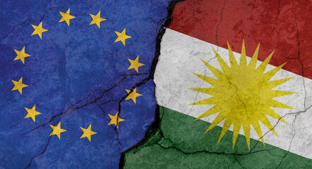 European Union and Kurdistan flags, concrete wall texture with cracks, grunge background, military conflict concept