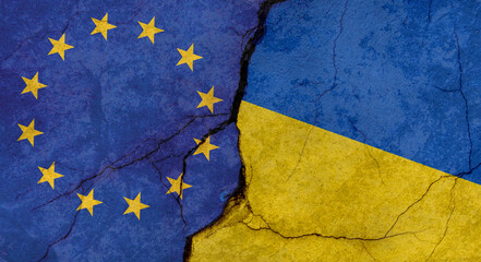European Union and Ukraine flags, concrete wall texture with cracks, grunge background, military conflict concept