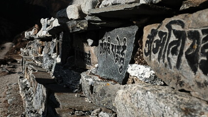 Buddhist signs on the way to Kyanjin Gompa village, Langtang Valley, Nepal