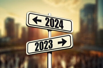 Road signs indicate the path to the new year 2024 and the old year 2023 in modern city with sunset, creative idea. Choose a new road, concept. Change for the better. Business and success