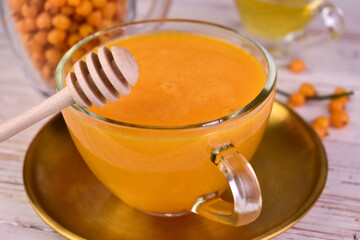 Tea from sea buckthorn berries in a cup. Close-up.