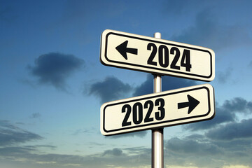 Road signs indicate the path to the new year 2024 and the old year 2023 on a blue sky, creative...