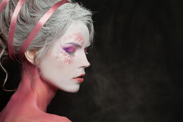 Closeup female face with magic fantasy makeup on black background - obrazy, fototapety, plakaty