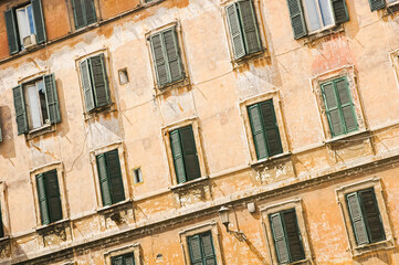 Fototapeta na wymiar Detail of typical facade of old Roman house with windows