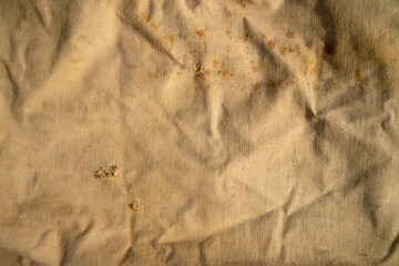 Photo of the texture of an old torn fabric. A torn bag. Vintage fabric background.