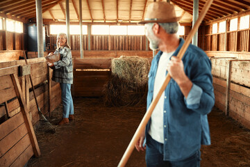 Mature couple working on the farm